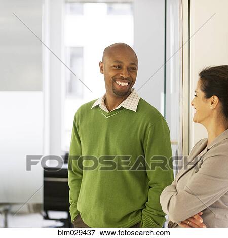 Stock Photo - Business people talking in office. Fotosearch