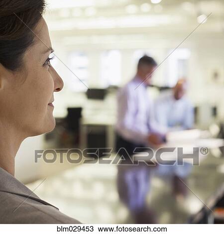 Businesswoman smiling in office View Large Photo Image Stock Image - Businesswoman smiling in office. Fotosearch