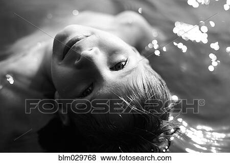 Caucasian boy swimming in water View Large Photo Image Stock Photo - Caucasian boy swimming in water. Fotosearch