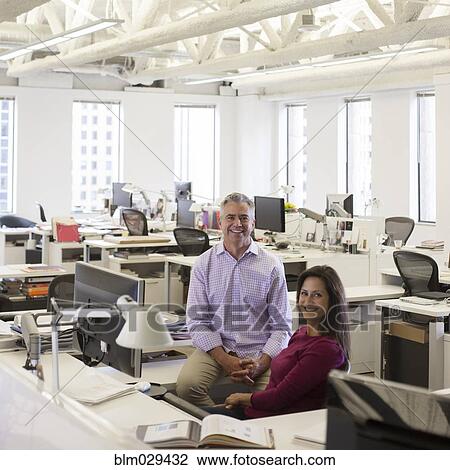 Stock Image - Caucasian business people smiling in office. Fotosearch