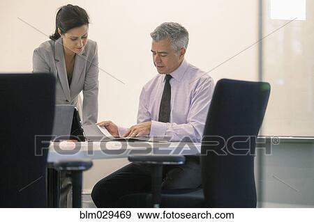 Stock Photo - Caucasian business people talking in meeting. Fotosearch