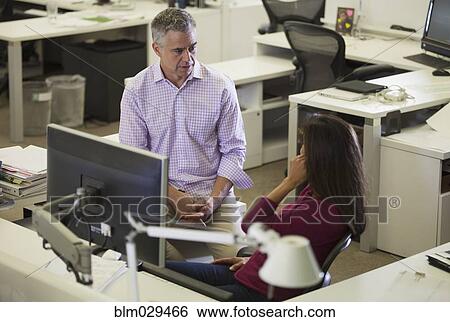 Stock Photograph - Caucasian business people talking in office. Fotosearch