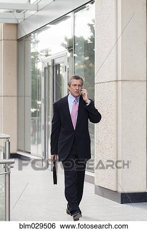 Caucasian businessman on cell phone outdoors View Large Photo Image Stock Photograph - Caucasian businessman on cell phone outdoors. Fotosearch