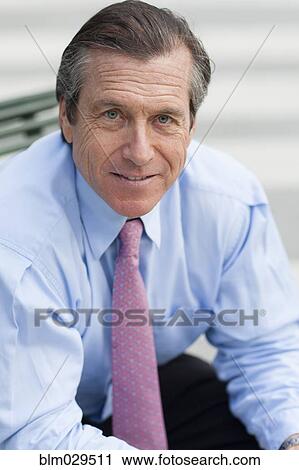 Stock Image - Caucasian businessman smiling outdoors. Fotosearch