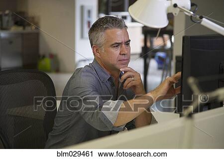 Caucasian businessman working at desk View Large Photo Image Stock Image - Caucasian businessman working at desk. Fotosearch