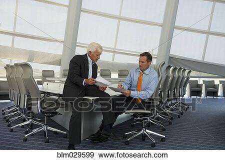 Caucasian businessmen talking in conference room View Large Photo Image Stock Photo - Caucasian businessmen talking in conference room. Fotosearch