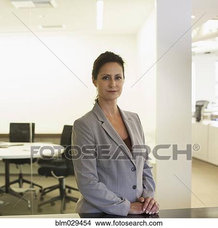 Caucasian businesswoman smiling in office View Large Photo Image Picture - Caucasian businesswoman smiling in office. Fotosearch