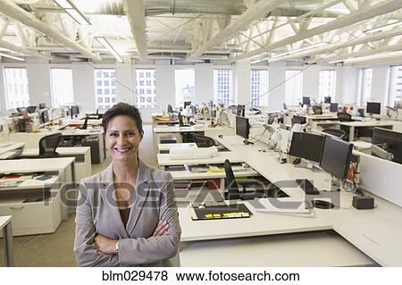 Caucasian businesswoman smiling in office View Large Photo Image Stock Photo - Caucasian businesswoman smiling in office. Fotosearch