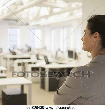 Stock Photo - Caucasian businesswoman standing in office. Fotosearch