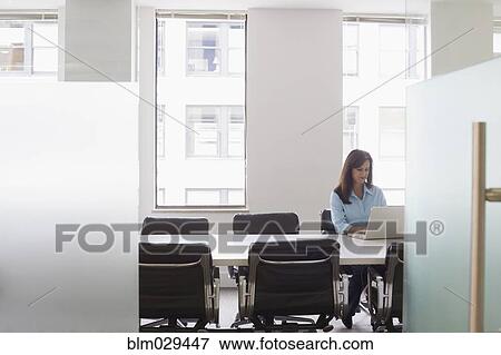 Caucasian businesswoman working in meeting room View Large Photo Image Stock Photo - Caucasian businesswoman working in meeting room. Fotosearch