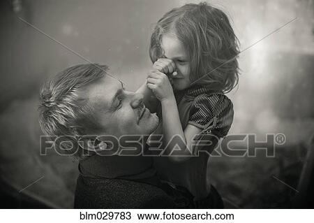 Caucasian father and daughter playing outdoors View Large Photo Image Stock Image - Caucasian father and daughter playing outdoors. Fotosearch