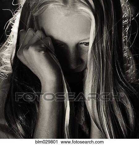 Stock Image - Caucasian girl covering her face. Fotosearch