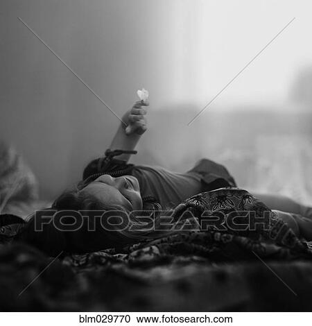 Caucasian girl laying on blanket with butterfly on finger View Large Photo Image Stock Image - Caucasian girl laying on blanket with butterfly on finger. Fotosearch