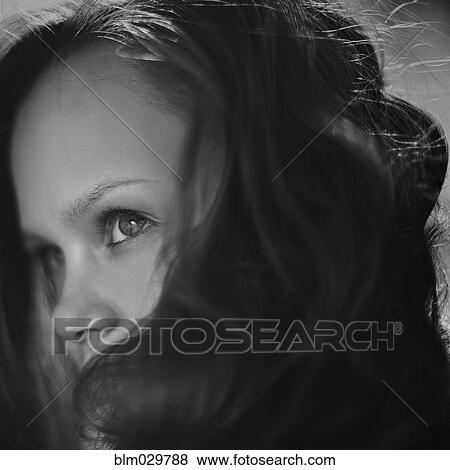 Stock Photo - Caucasian girl peering over her hair. Fotosearch