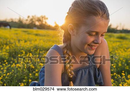 Caucasian girl smiling in field of flowers View Large Photo Image Picture - Caucasian girl smiling in field of flowers. Fotosearch