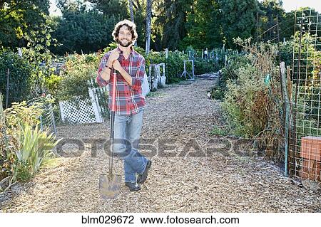 Stock Image - Caucasian man standing in garden. Fotosearch