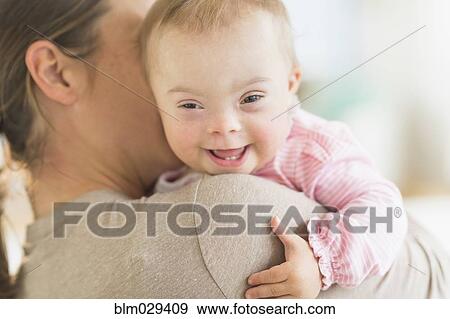 Caucasian mother holding baby girl with Down Syndrome View Large Photo Image Stock Photo - Caucasian mother holding baby girl with Down Syndrome. Fotosearch