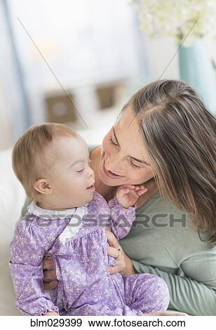 Caucasian mother playing with baby with Down Syndrome View Large Photo Image Stock Photo - Caucasian mother playing with baby with Down Syndrome. Fotosearch