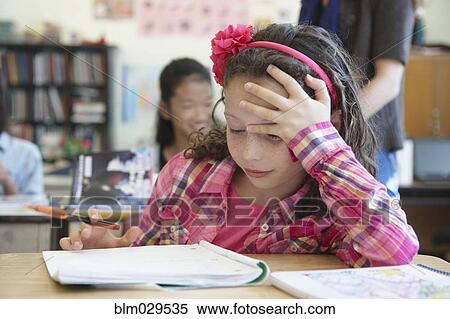 Stock Photography - Caucasian student working in class. Fotosearch