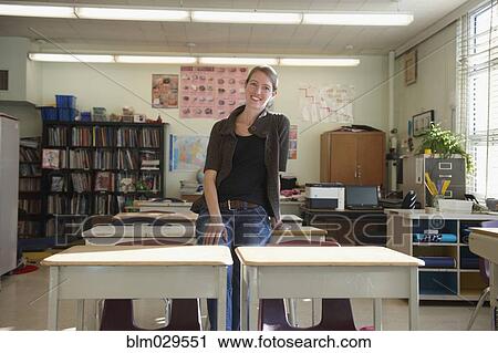 Caucasian teacher smiling in classroom View Large Photo Image Stock Image - Caucasian teacher smiling in classroom. Fotosearch