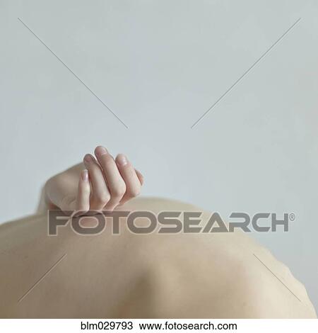 Stock Image - Caucasian woman holding pregnant belly. Fotosearch