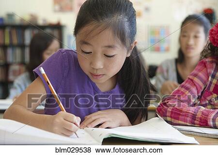 Stock Photo - Chinese student working in class. Fotosearch