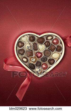 Stock Image - Close up of heart-shaped box of chocolates. Fotosearch