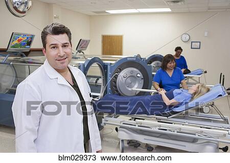 Doctor standing in hyperbaric chamber room View Large Photo Image Stock Image - Doctor standing in hyperbaric chamber room. Fotosearch