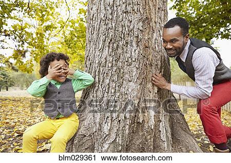 Father and son playing in park View Large Photo Image Stock Image - Father and son playing in park. Fotosearch