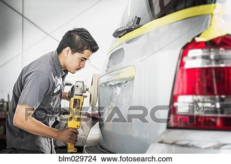 Picture - Hispanic mechanic working in auto shop. Fotosearch