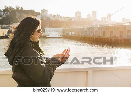 Stock Photo - Hispanic woman on boardwalk, San Francisco, California, United States. Fotosearch