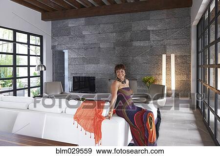 Hispanic woman smiling in living room View Large Photo Image Stock Photo - Hispanic woman smiling in living room. Fotosearch