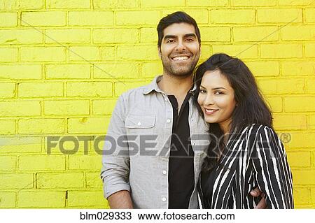 Indian couple hugging in front of yellow brick wall View Large Photo Image Stock Image - Indian couple hugging in front of yellow brick wall. Fotosearch