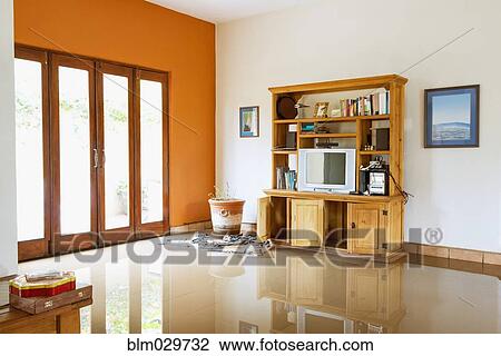Stock Image - Media center and windows of flooded house. Fotosearch