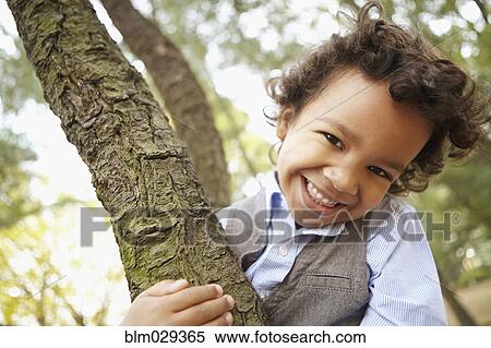 Mixed race boy smiling in park View Large Photo Image Stock Photography - Mixed race boy smiling in park. Fotosearch