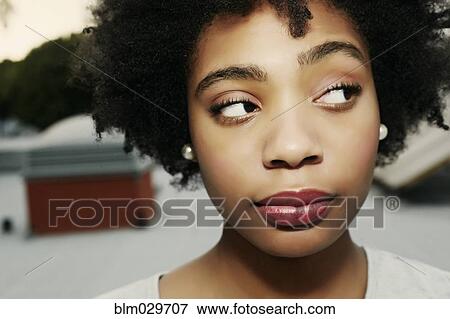 Mixed race woman arching an eyebrow View Large Photo Image Stock Photo - Mixed race woman arching an eyebrow. Fotosearch