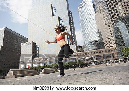 Stock Photo - Mixed race woman working out on city street. Fotosearch