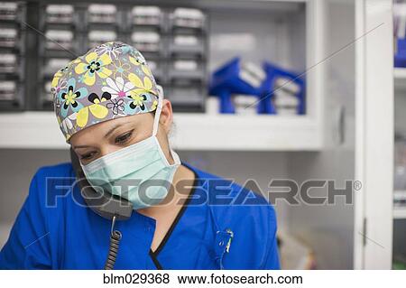 Nurse talking on phone in operating room View Large Photo Image Stock Photo - Nurse talking on phone in operating room. Fotosearch