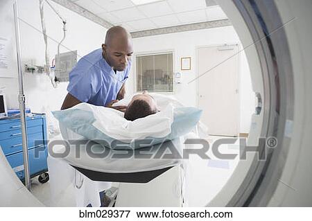 Stock Photo - Nurse talking to patient before CAT scan. Fotosearch