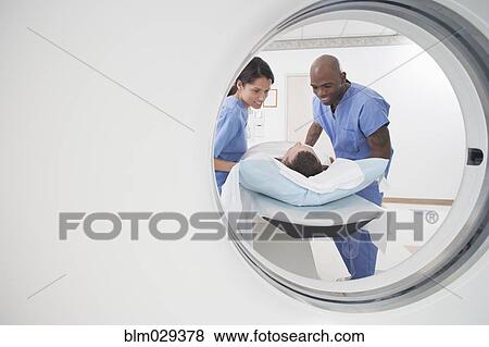 Nurses talking to patient before CAT scan View Large Photo Image Stock Photo - Nurses talking to patient before CAT scan. Fotosearch
