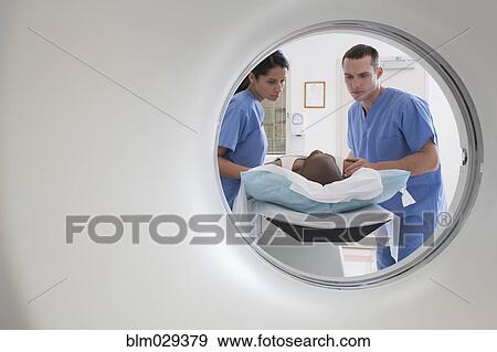 Nurses talking to patient before CAT scan View Large Photo Image Stock Photo - Nurses talking to patient before CAT scan. Fotosearch