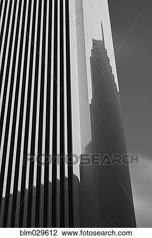 Skyscraper casting shadow on office building View Large Photo Image Stock Image - Skyscraper casting shadow on office building. Fotosearch