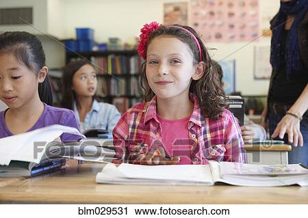 Stock Image - Student smiling in class. Fotosearch