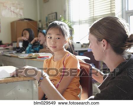 Student working with teacher in class View Large Photo Image Stock Photo - Student working with teacher in class. Fotosearch