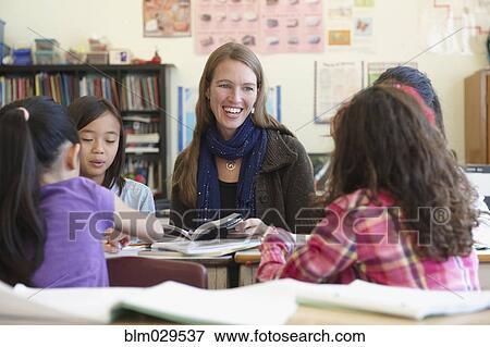 Stock Photo - Students and teacher working in class. Fotosearch