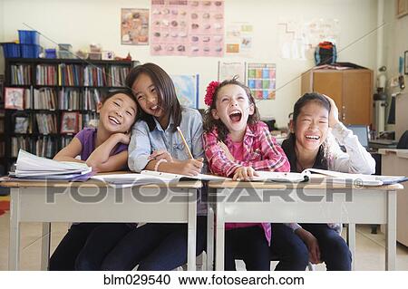 Stock Image - Students laughing in class. Fotosearch