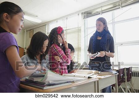 Students listening to teacher in class View Large Photo Image Stock Image - Students listening to teacher in class. Fotosearch