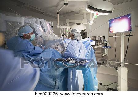 Surgeons working on patient in operating room View Large Photo Image Stock Photograph - Surgeons working on patient in operating room. Fotosearch