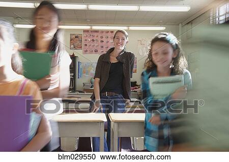 Teacher watching students leave classroom View Large Photo Image Stock Image - Teacher watching students leave classroom. Fotosearch