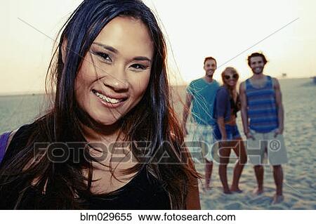 Stock Photography - Woman smiling on beach. Fotosearch